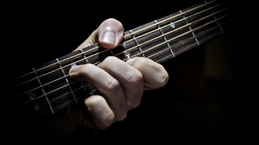 A Guitar Chord With Thumb Iamge